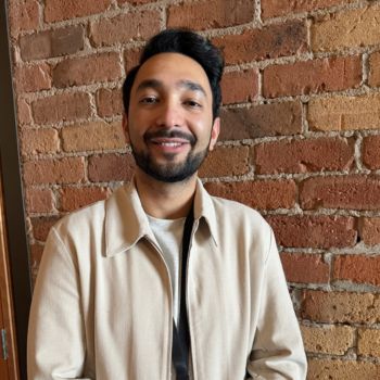 Image of Akhil in front of brick wall