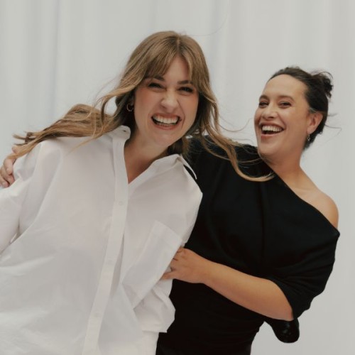 An image of Bryn and Ku smiling and holding onto one antoher