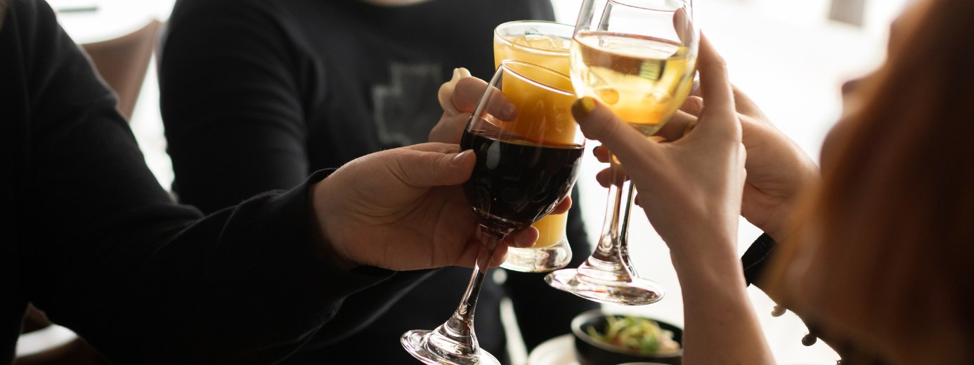 Q Beverages - people cheersing with wine glasses