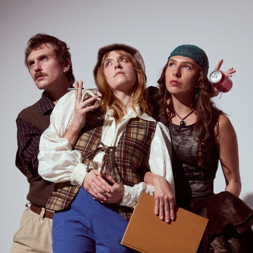 Three people photographed against a white wall